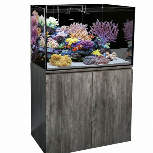 A large rectangular aquarium with a dark wood-grain cabinet base, shown on a plain white background. The tank is filled with colorful coral and small fish, and the cabinet has a gray wood-look finish.